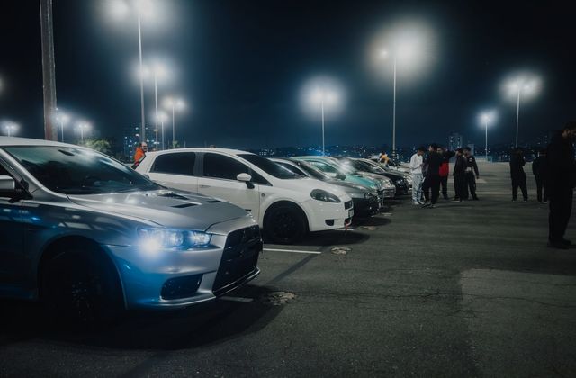 Cars and people at a night car meet